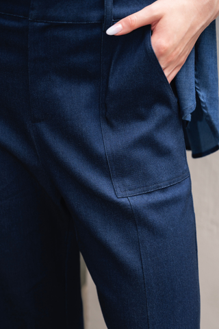 Close-up of a person wearing Olive Basics’ Jesse Wide-leg Pocket Pants in Denim TENCEL, with their right hand in the pocket and a light pink manicure visible.