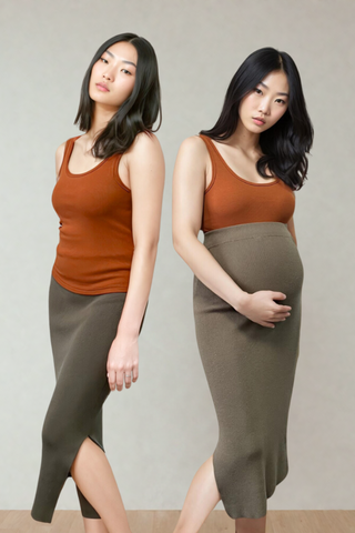 Two women stand side by side against a plain background, both wearing the Olive Basics Esther Easy Latch Tank with olive skirts; one gently holds her visible baby bump.