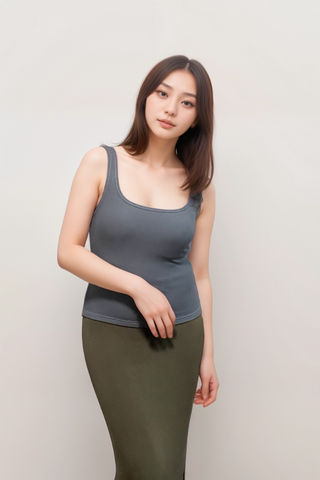A woman with straight brown hair wears the Olive Basics Esther Easy Latch Tank in gray with built-in bra padding and an olive green skirt, standing against a plain light background.