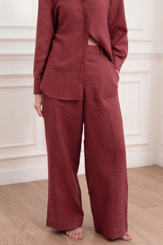 A woman wears a red suit with Olive Basics' Jesse Wide-leg Pocket Pants in TENCEL™ Linen, featuring an adjustable waistband.